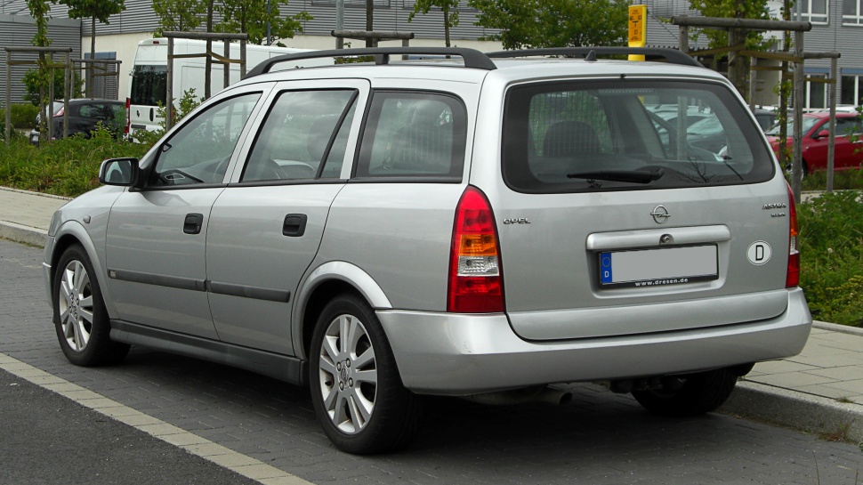 Silver station wagon rear side with roof rails and rear wiper