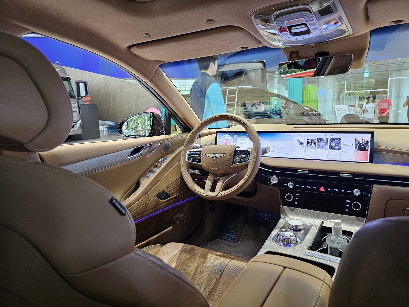 Tan leather interior with wide digital dashboard and advanced controls