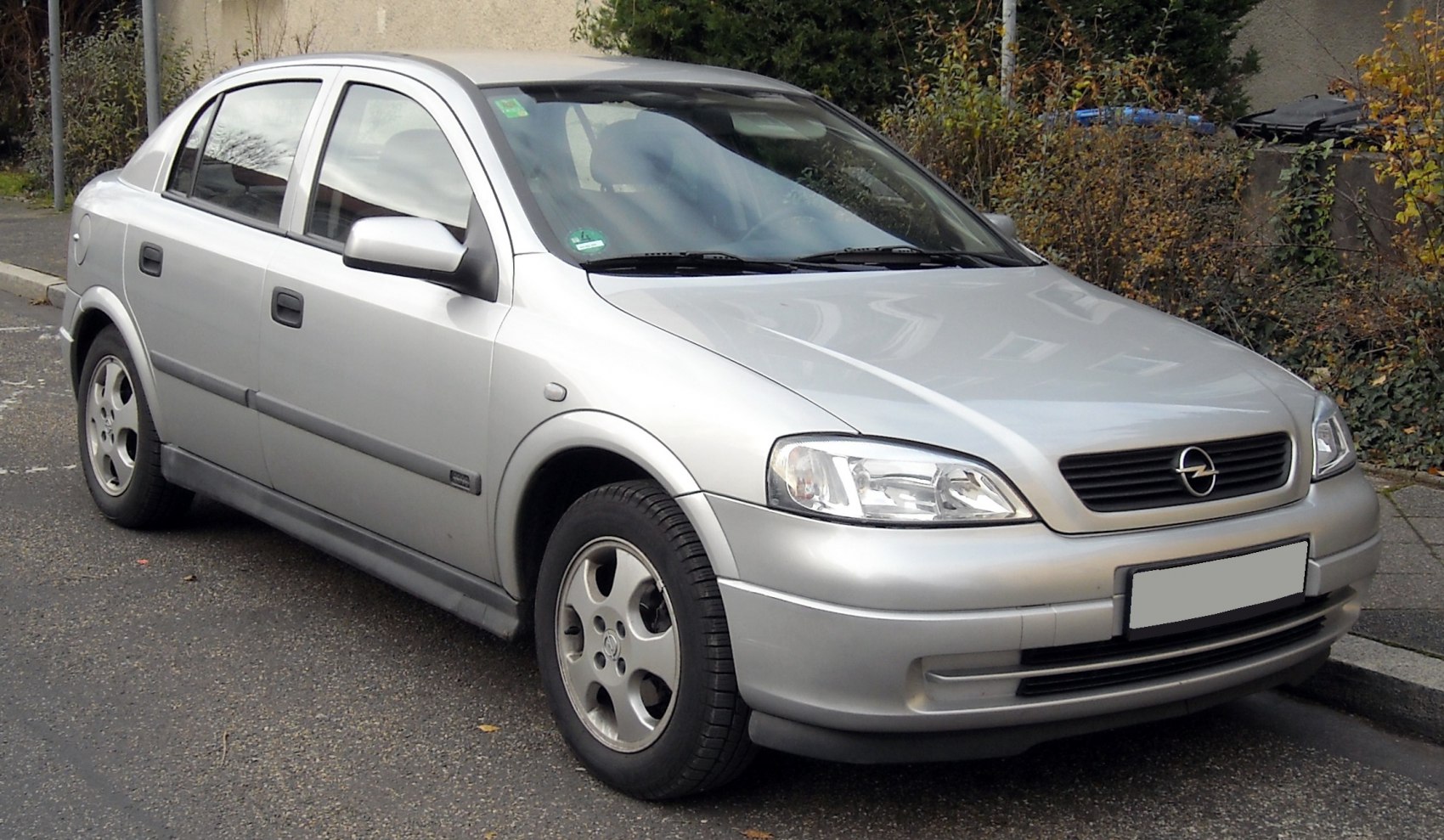 Silver four-door compact sedan with alloy wheels
