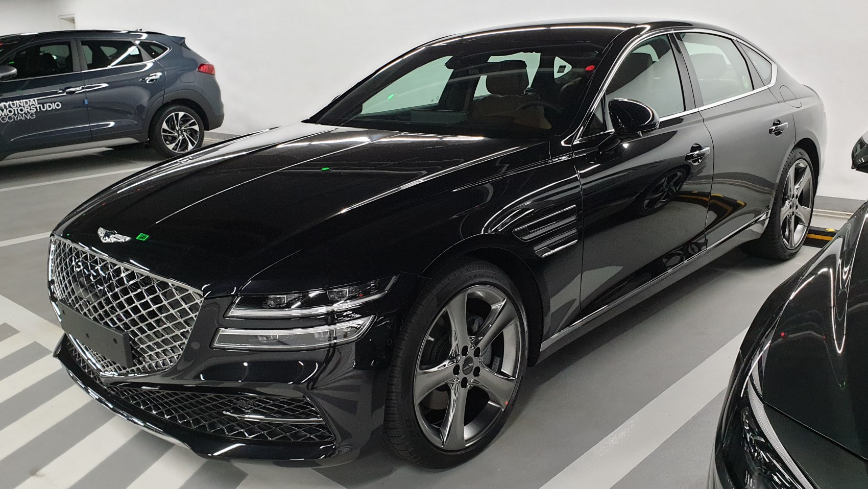 Luxury sedan with diamond-pattern front grille and LED headlights