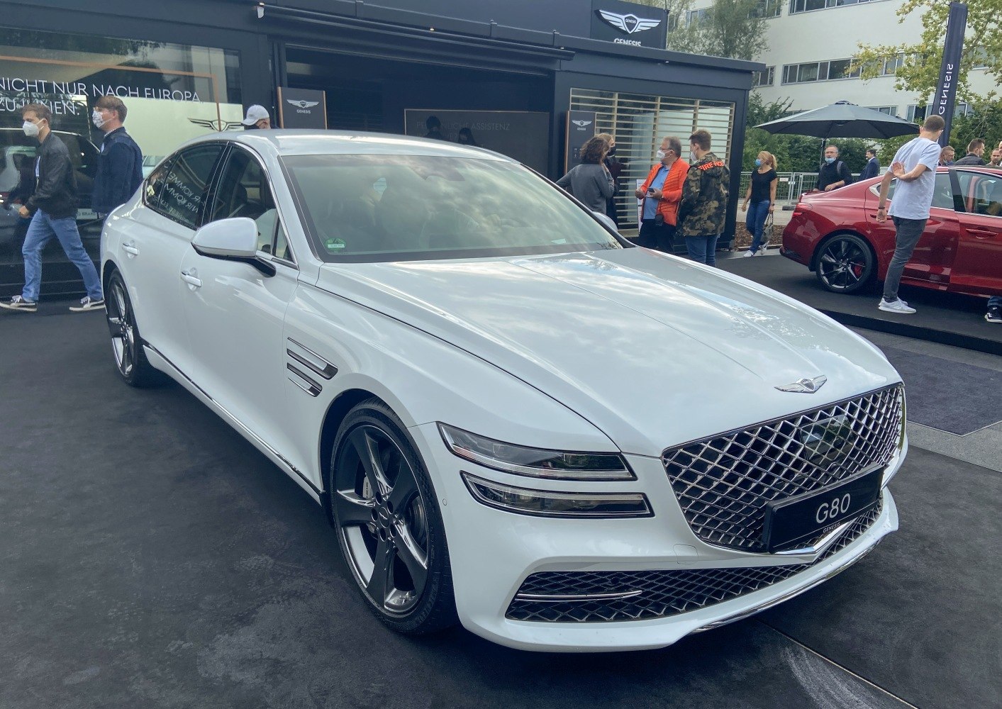 Front and side view of luxury sedan with LED headlights and large grille