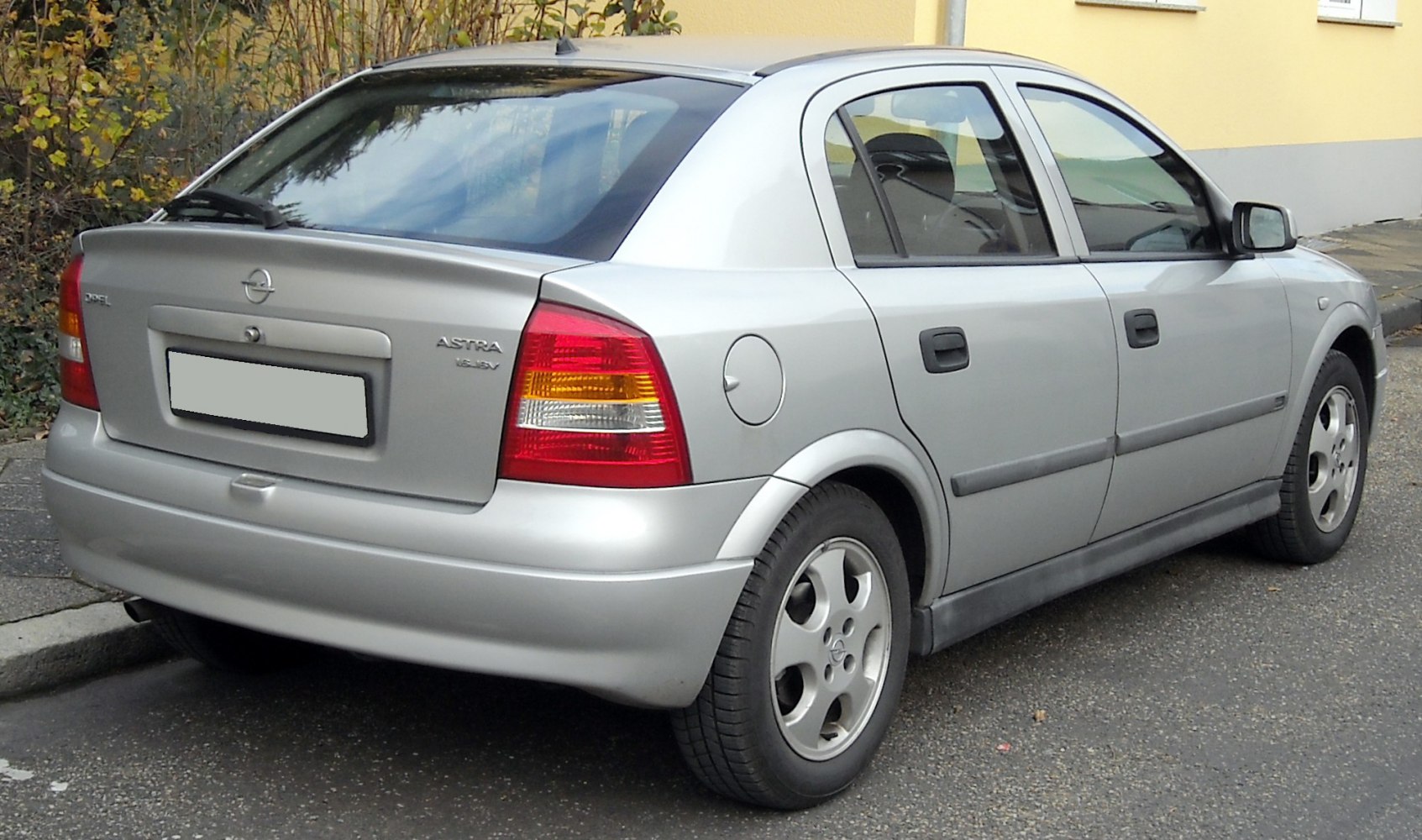 Rear side view of a silver sedan with distinctive rear lights and alloy wheels