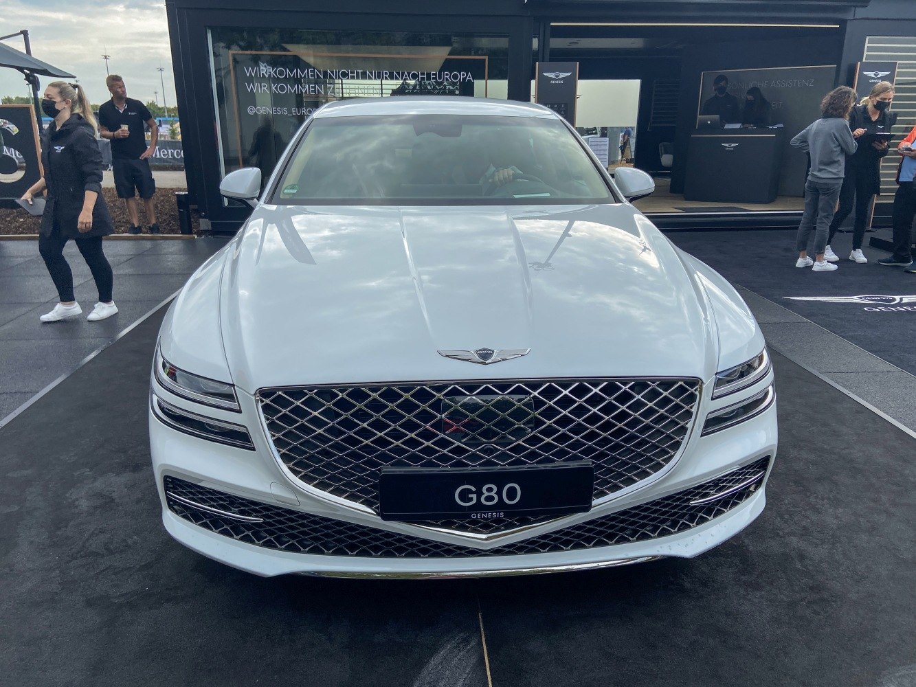 Luxury sedan front with mesh grille and split LED headlights