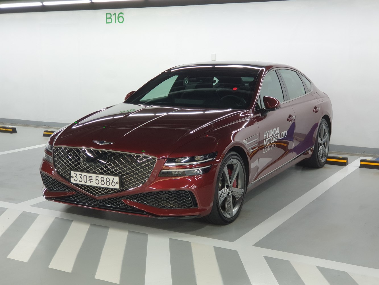 Luxury sedan with diamond-pattern grille and sporty five-spoke alloy wheels