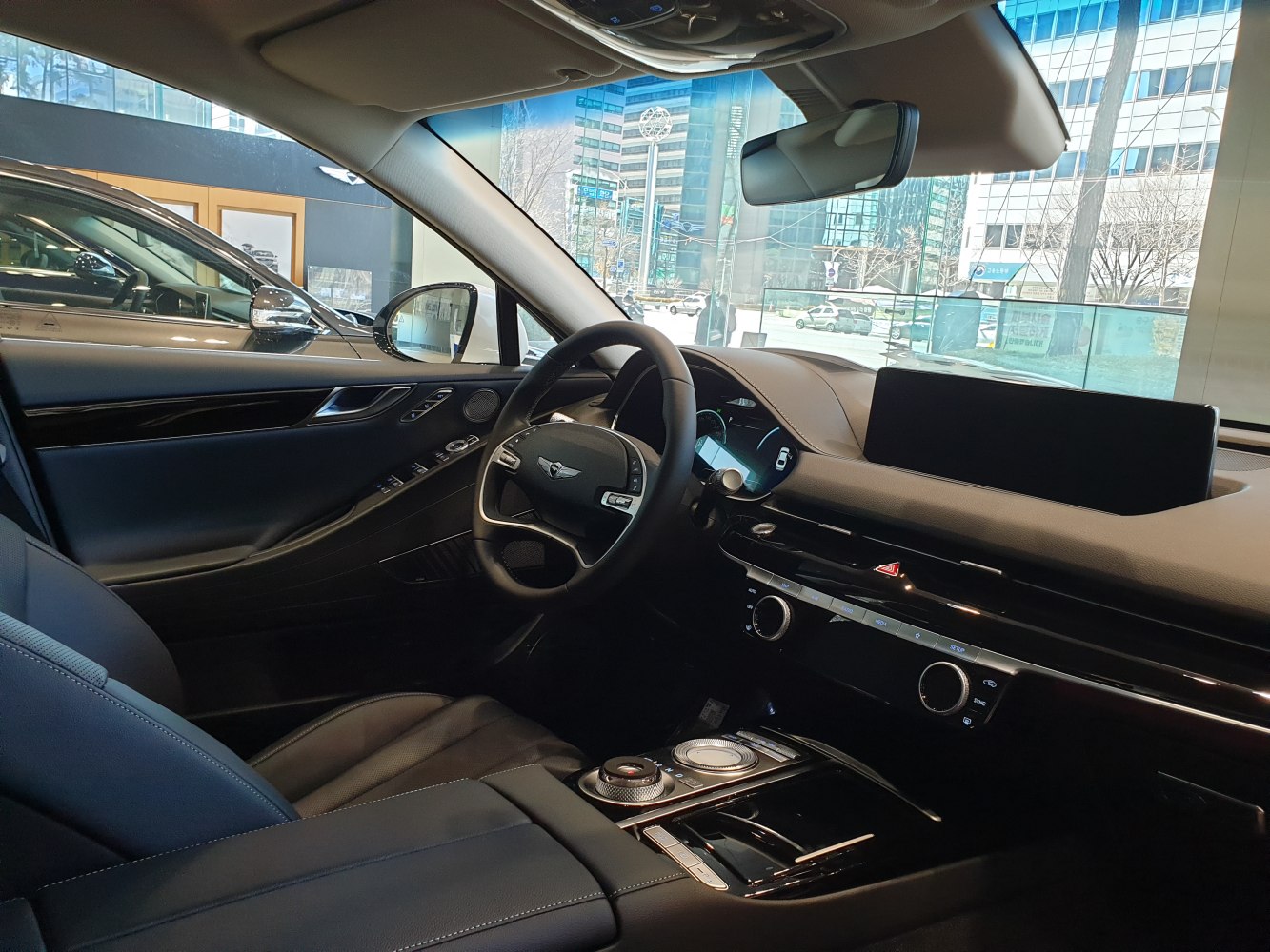 Luxury sedan interior with dashboard, digital display, and premium controls.