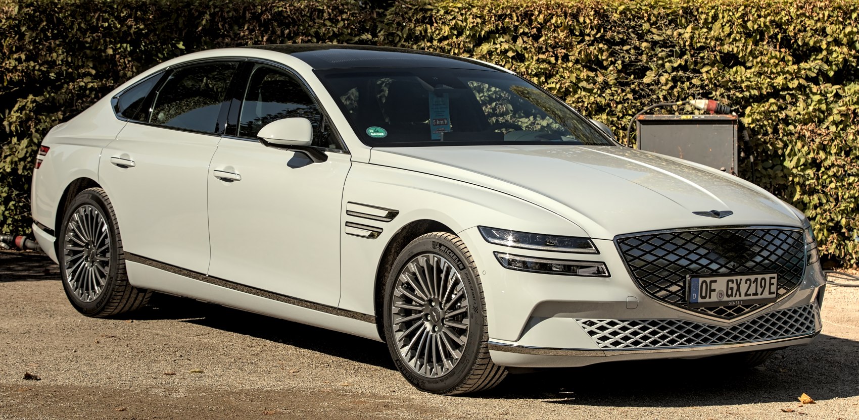 Luxury sedan with split LED headlights and diamond grille