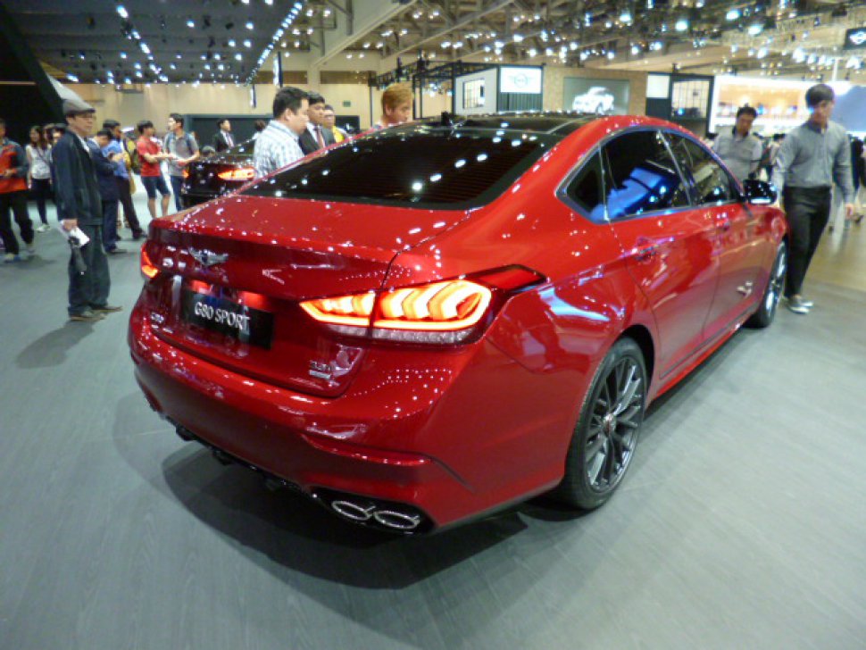 Rear view with distinctive tail lights and quad exhaust in red sedan
