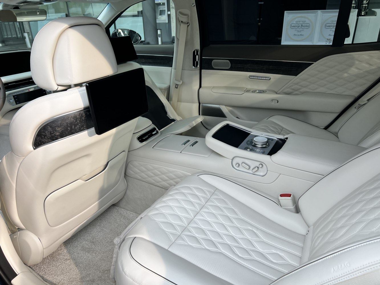 Quilted leather rear seats with entertainment screens and control panel