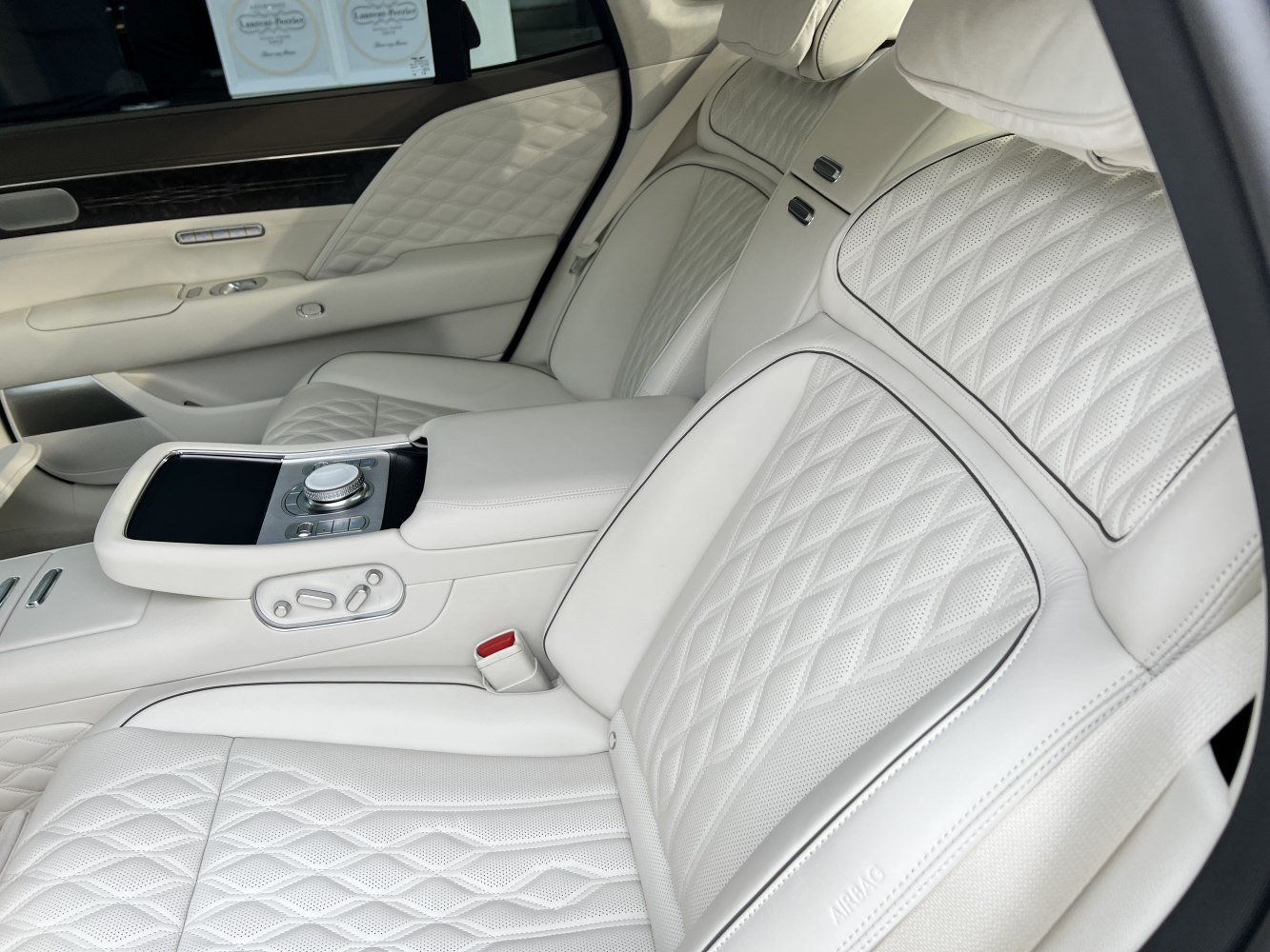 Quilted white leather rear seats with control console and armrest