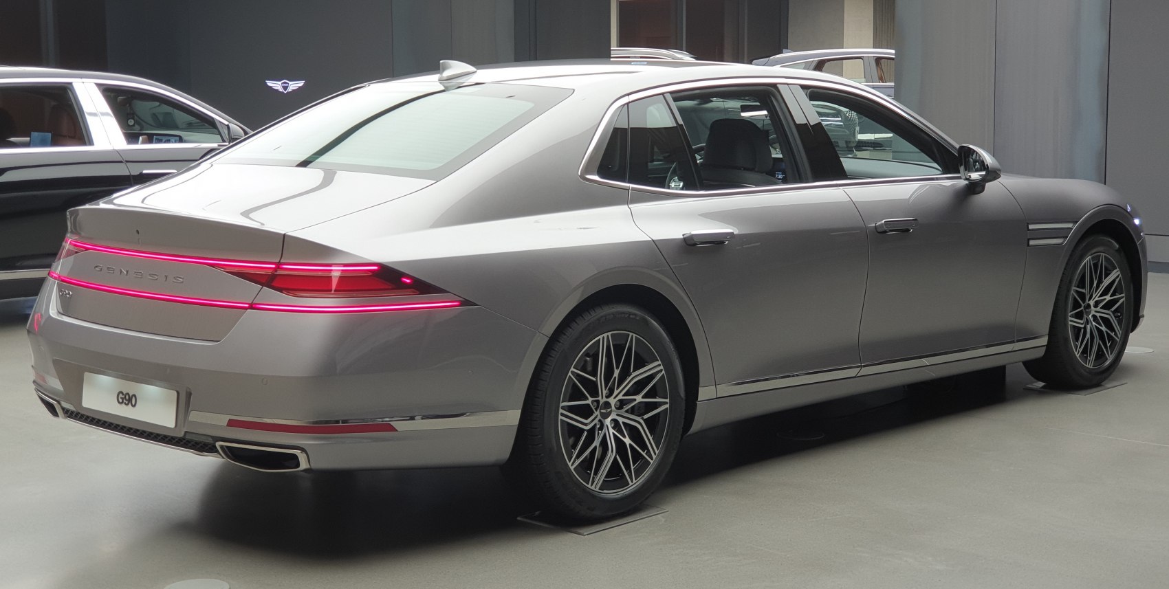 Rear and side view of luxury sedan with LED tail light strip and alloy wheels