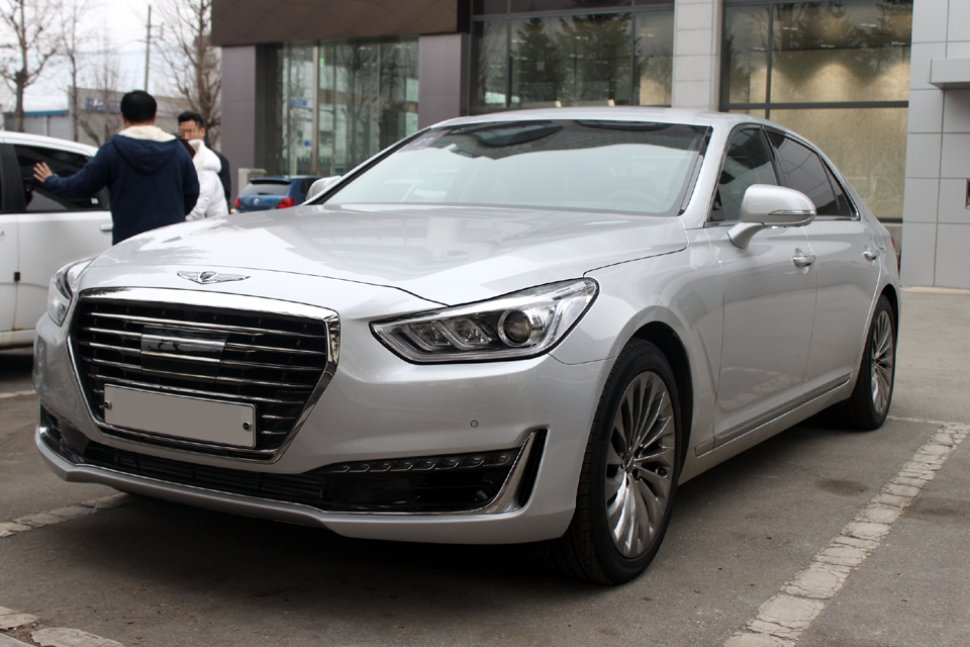Front view of luxury sedan with prominent grille and sleek LED headlights