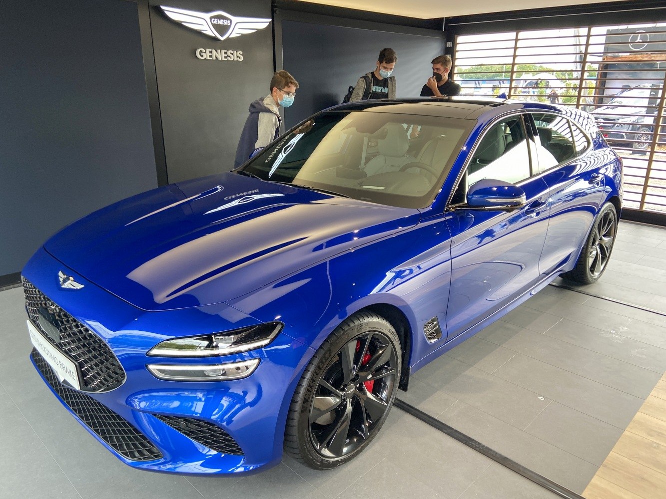 Blue sporty luxury station wagon with black alloy wheels and sleek aerodynamic lines
