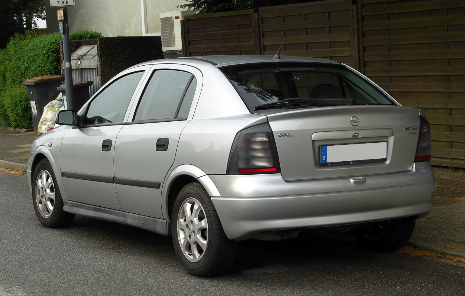 Smoked tail lights and silver metallic hatchback rear view