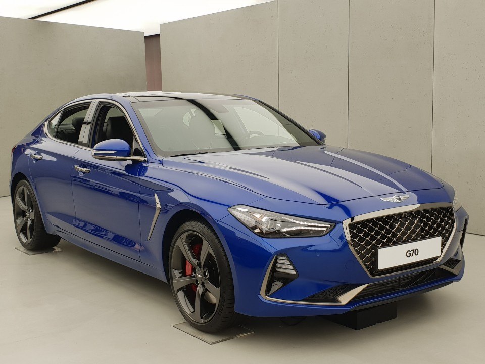 Blue sedan with prominent front grille and sharp headlights
