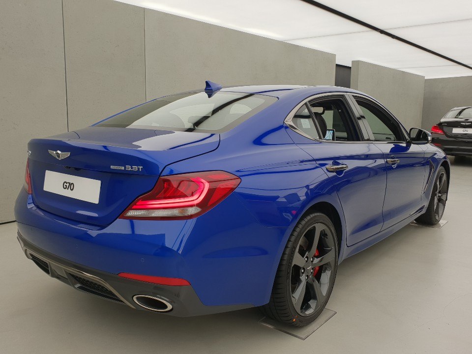 Rear view of sedan with LED tail lights and dual exhaust