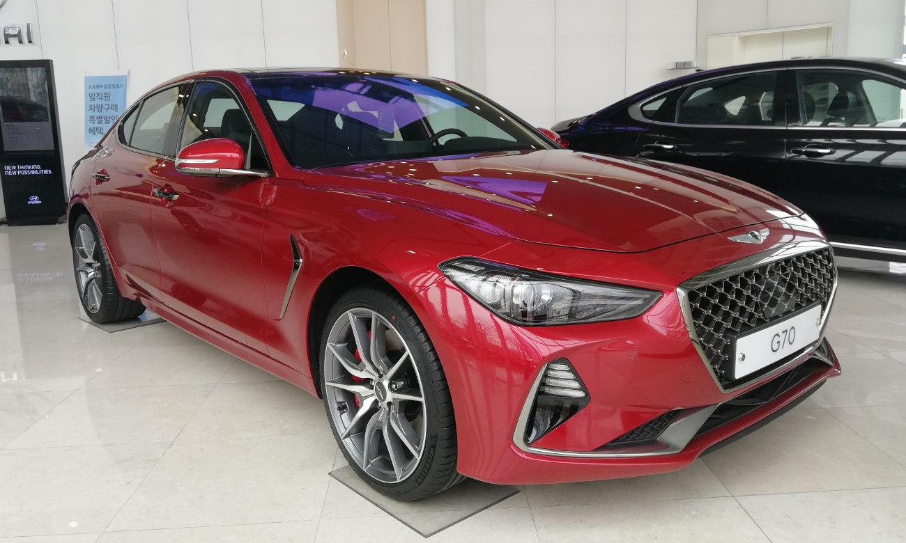 Red sedan with aggressive front grille and sharp LED headlights