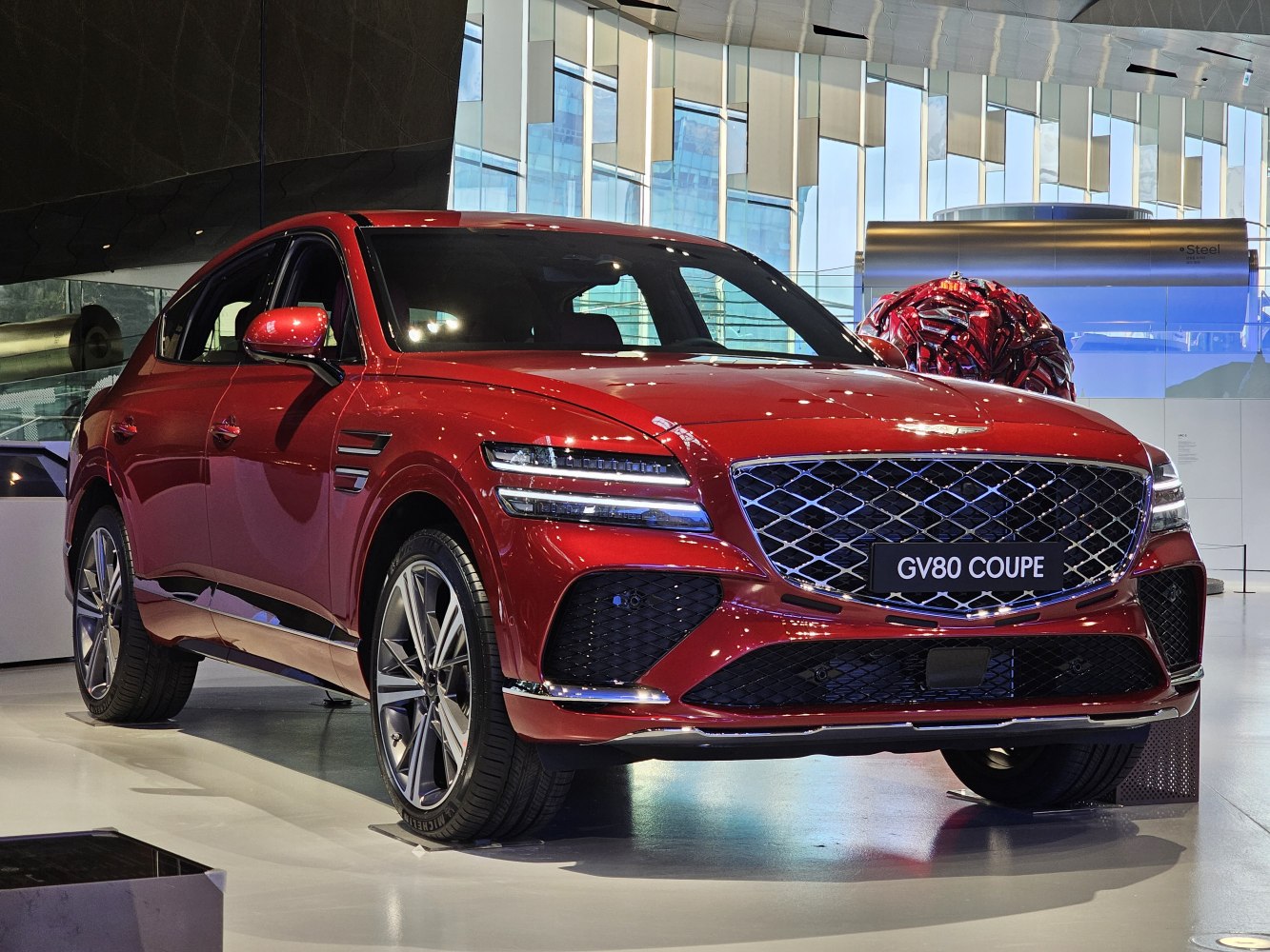 Luxury red SUV with diamond-pattern grille and LED headlights
