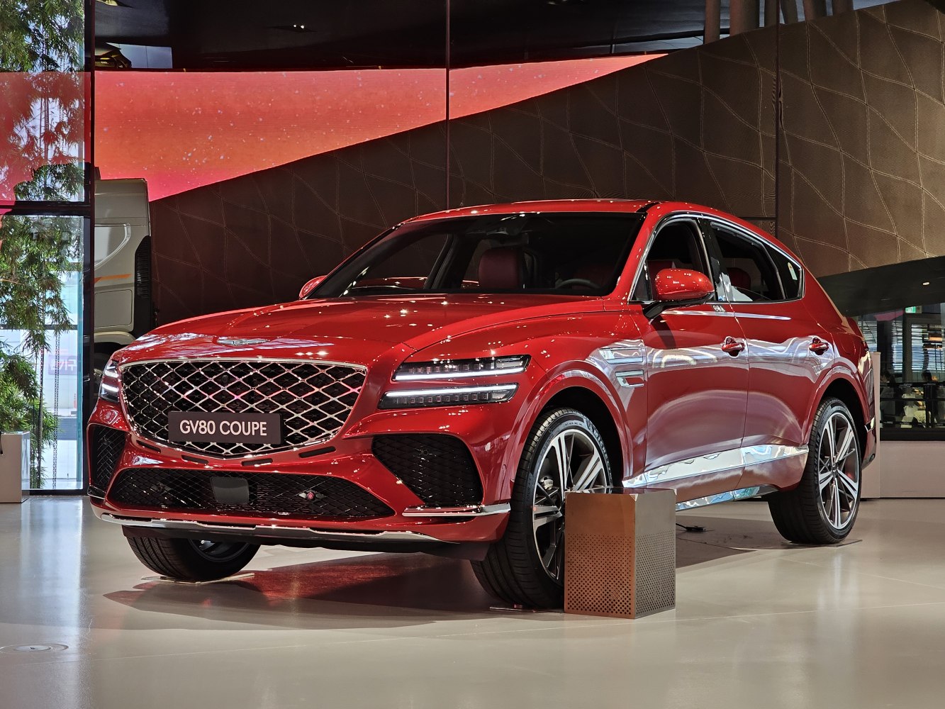 Red luxury SUV with mesh grille and slim LED headlights