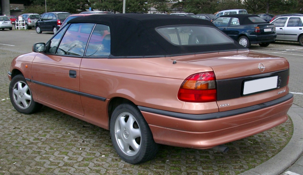 Rear view of a 1994 convertible with closed black soft top and tail lights