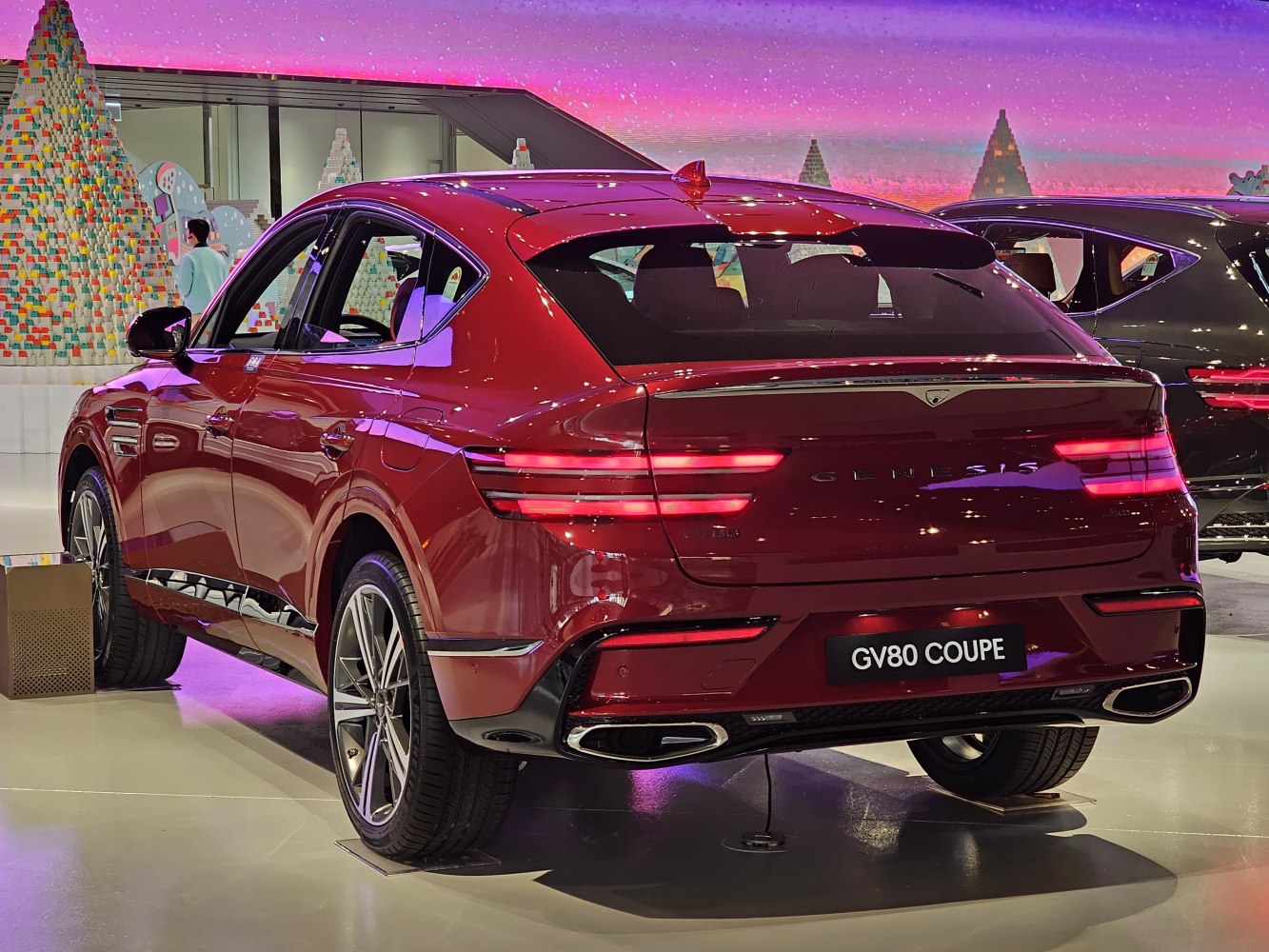 Rear view with LED tail lights and dual exhausts of a luxury SUV coupe