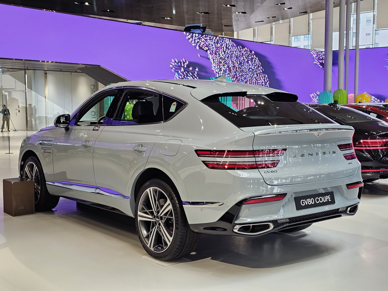 Rear view of a luxury coupe SUV with LED taillights and dual exhaust tips