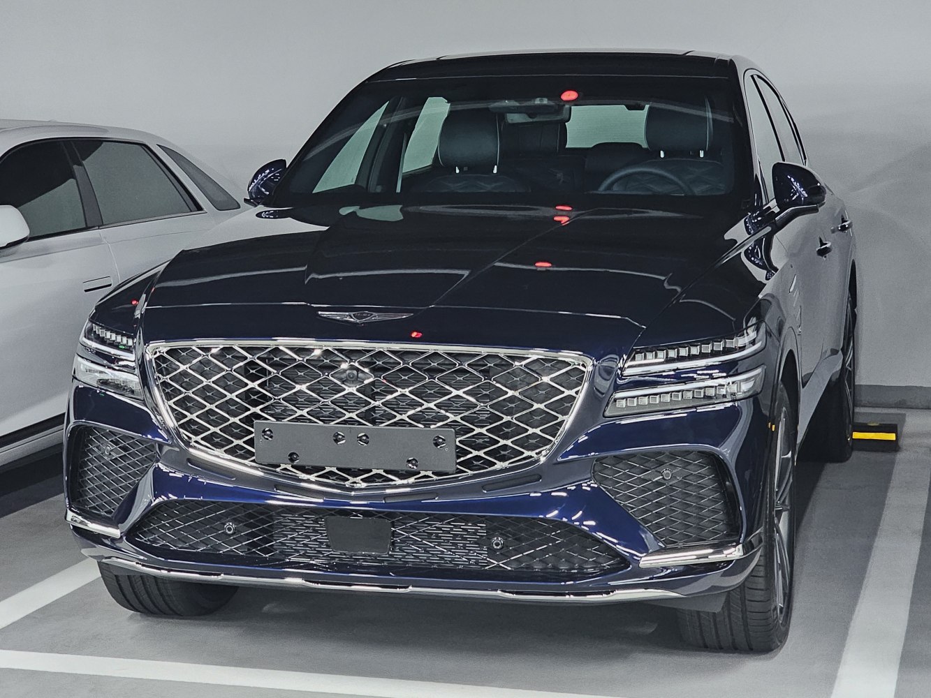 Diamond-pattern grille with split LED headlights and chrome details