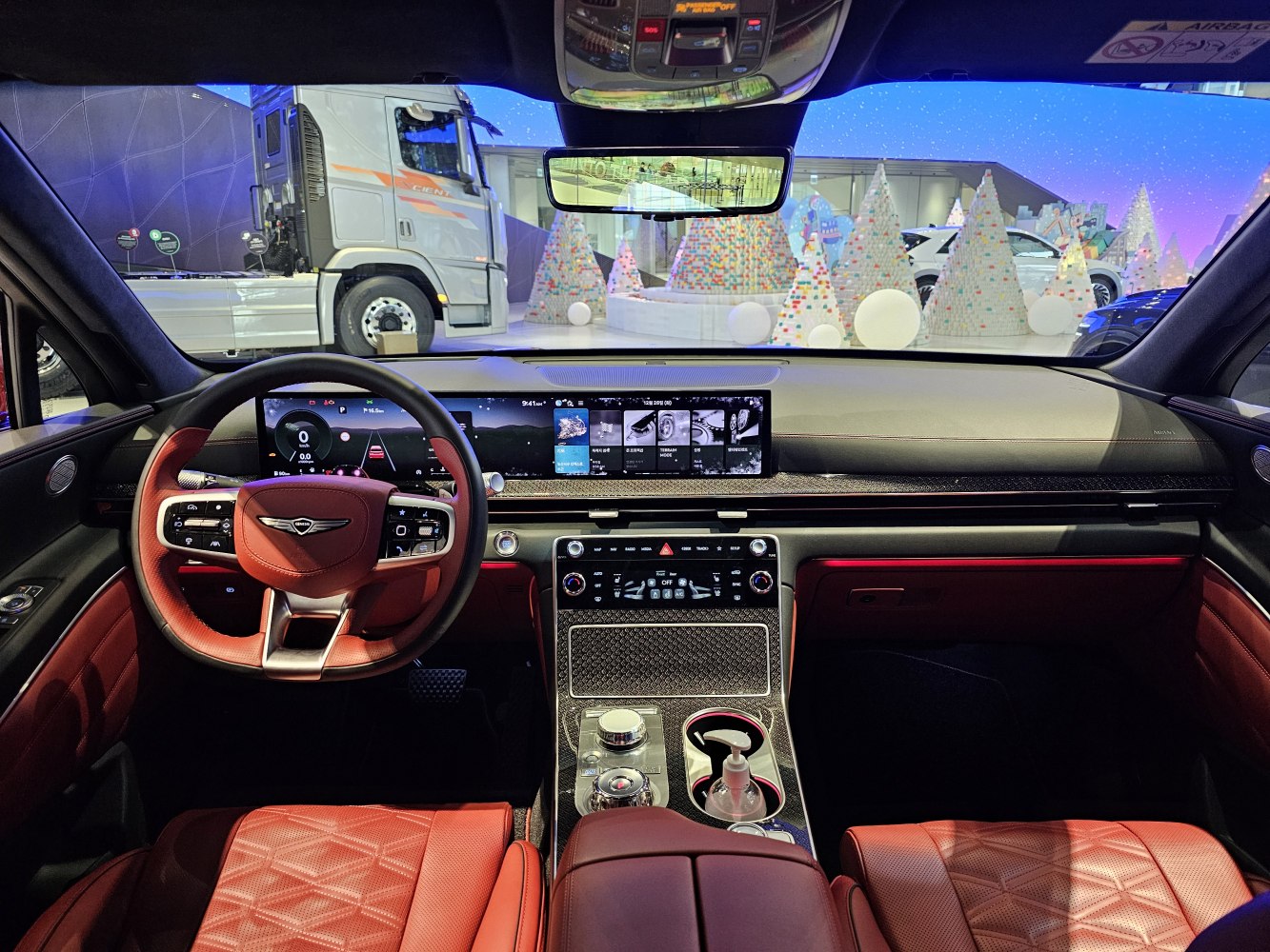 Digital dashboard and red leather seats in luxury vehicle interior