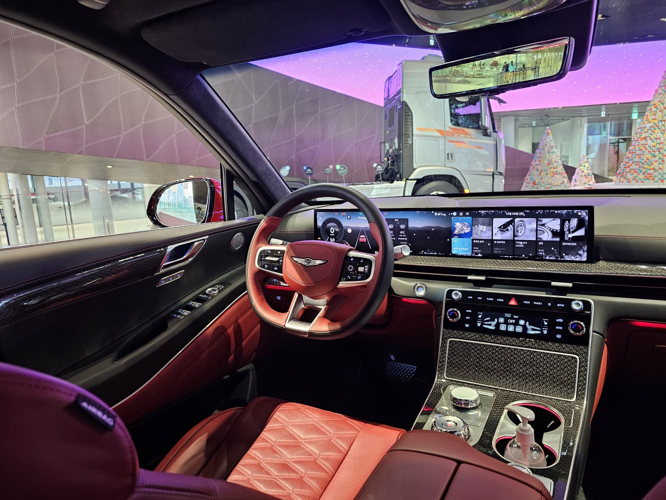 Luxury SUV interior with panoramic digital dashboard and red leather upholstery