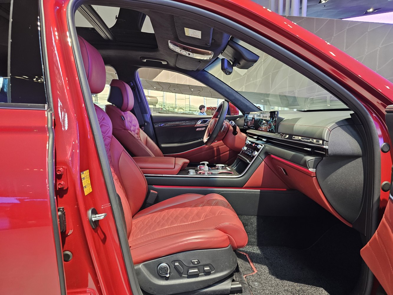 Red leather seats and advanced digital dashboard in a luxury SUV interior