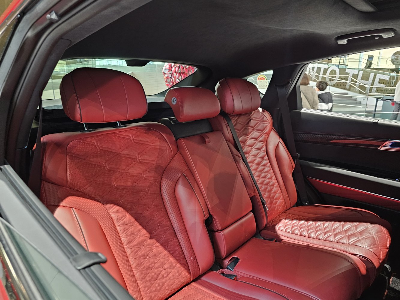 Red quilted leather rear seats with headrests and premium stitching.