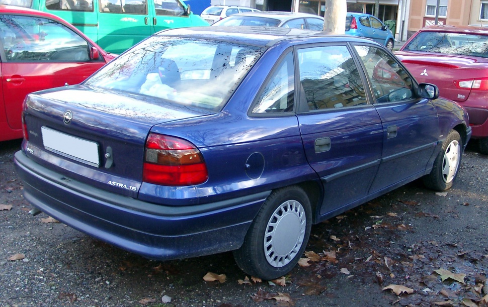 Rear side view of dark blue 1994 hatchback with distinctive taillights and body contours