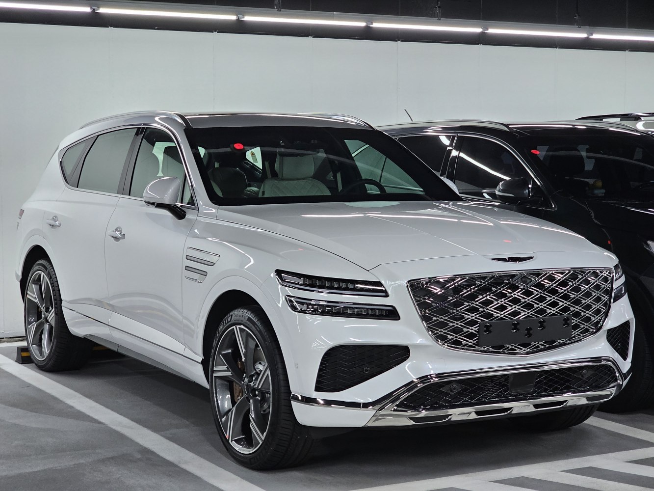 Luxury SUV with split LED headlights and large chrome grille