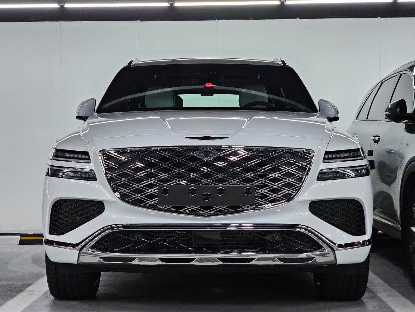 Front view of luxury SUV with large mesh grille and sleek LED headlights