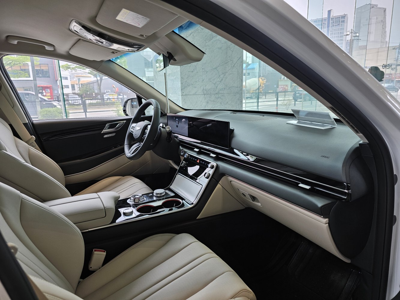 Luxury beige leather seats with digital dashboard and modern central console.