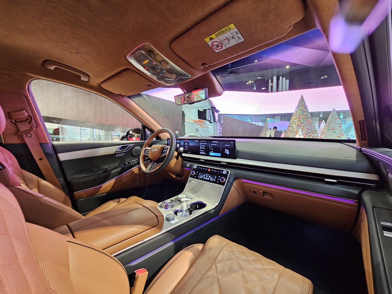 Tan leather interior with advanced digital dashboard and ambient lighting