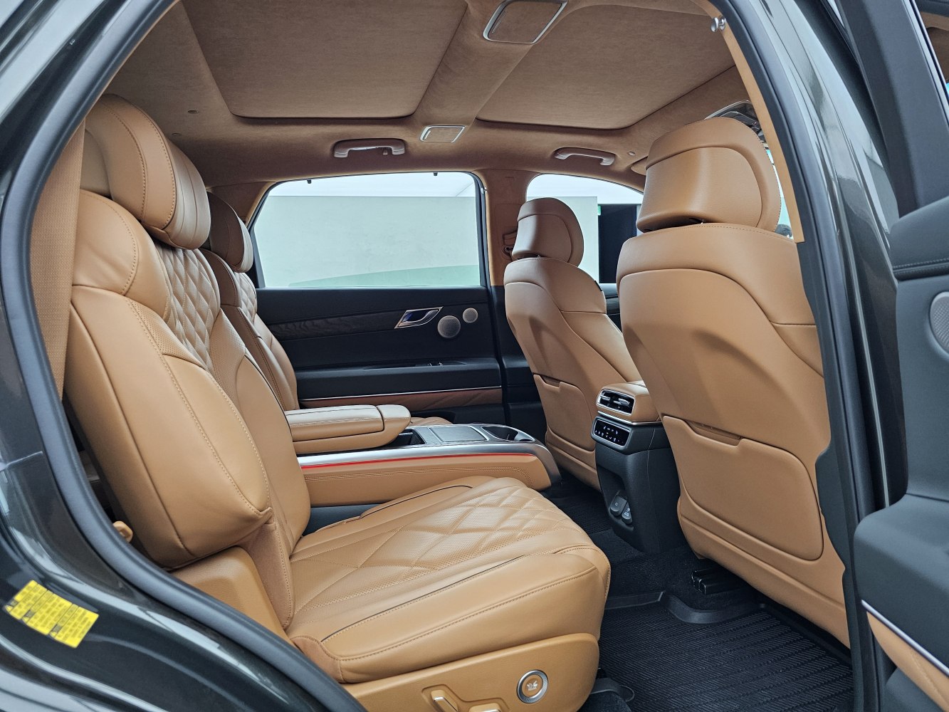 Luxurious tan leather rear seats with quilted design and premium interior details