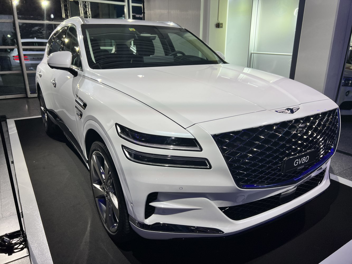 Luxury SUV with large diamond-pattern grille and split LED headlights