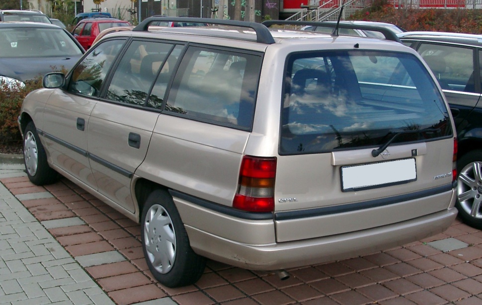 Rear and side view of beige station wagon with roof rails and rear wiper
