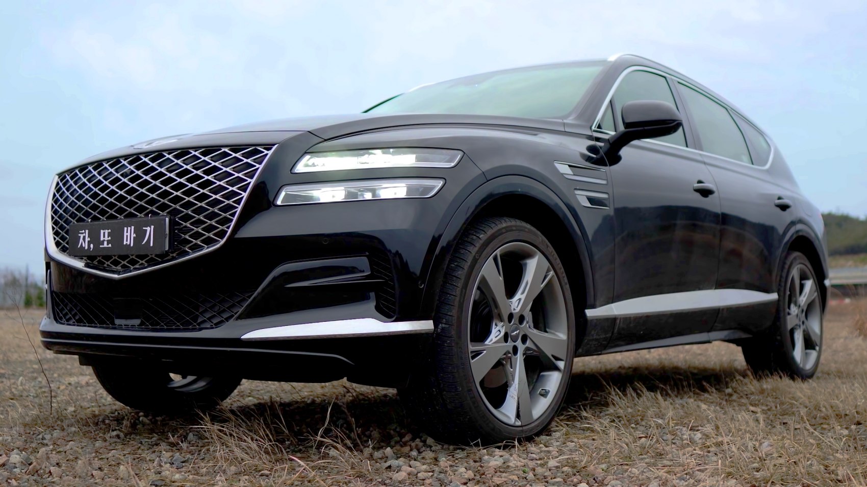 Close-up of SUV front showing diamond grille and split LED headlights
