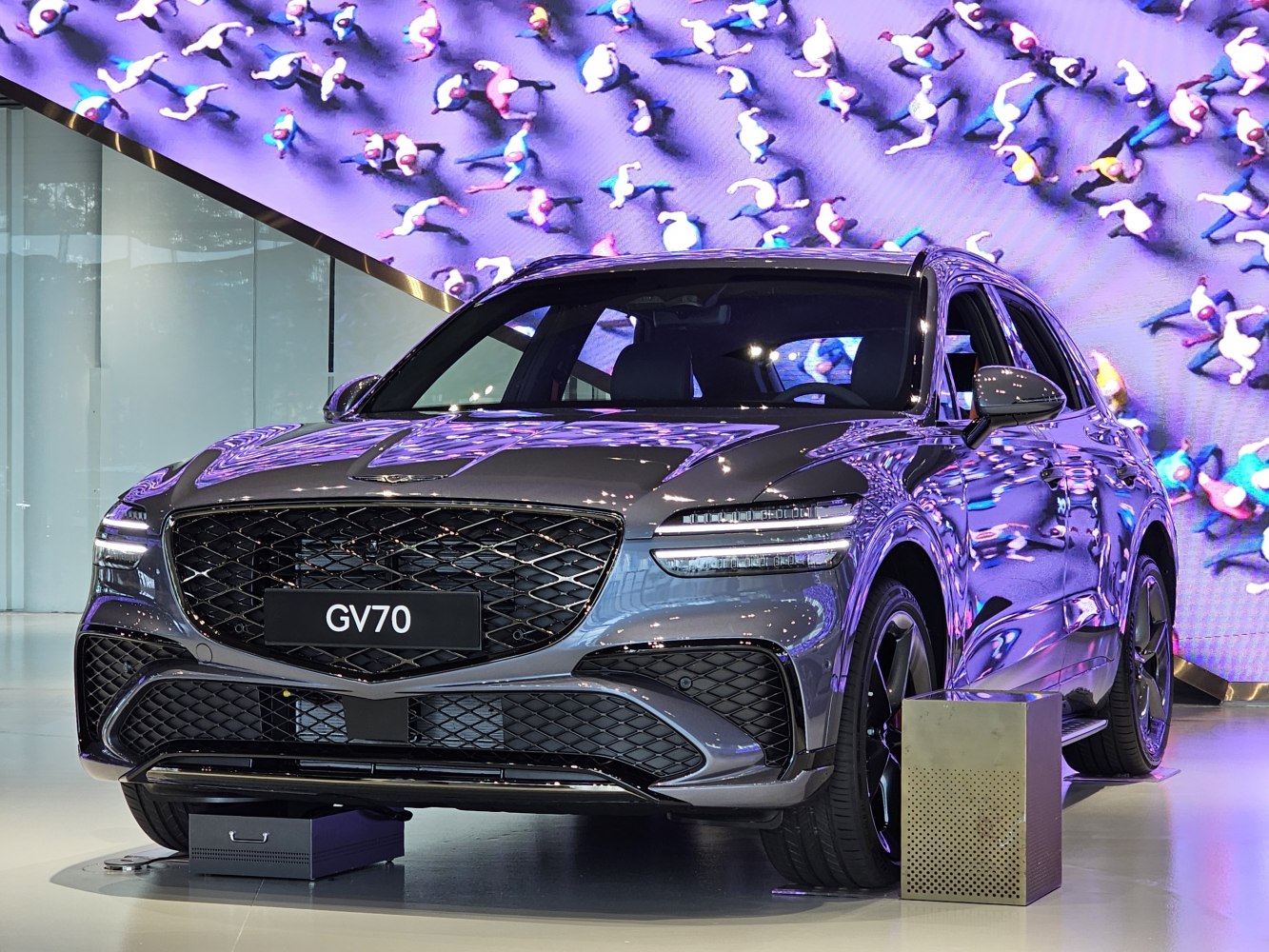 Front view of a modern SUV with sleek LED headlights and large mesh grille.