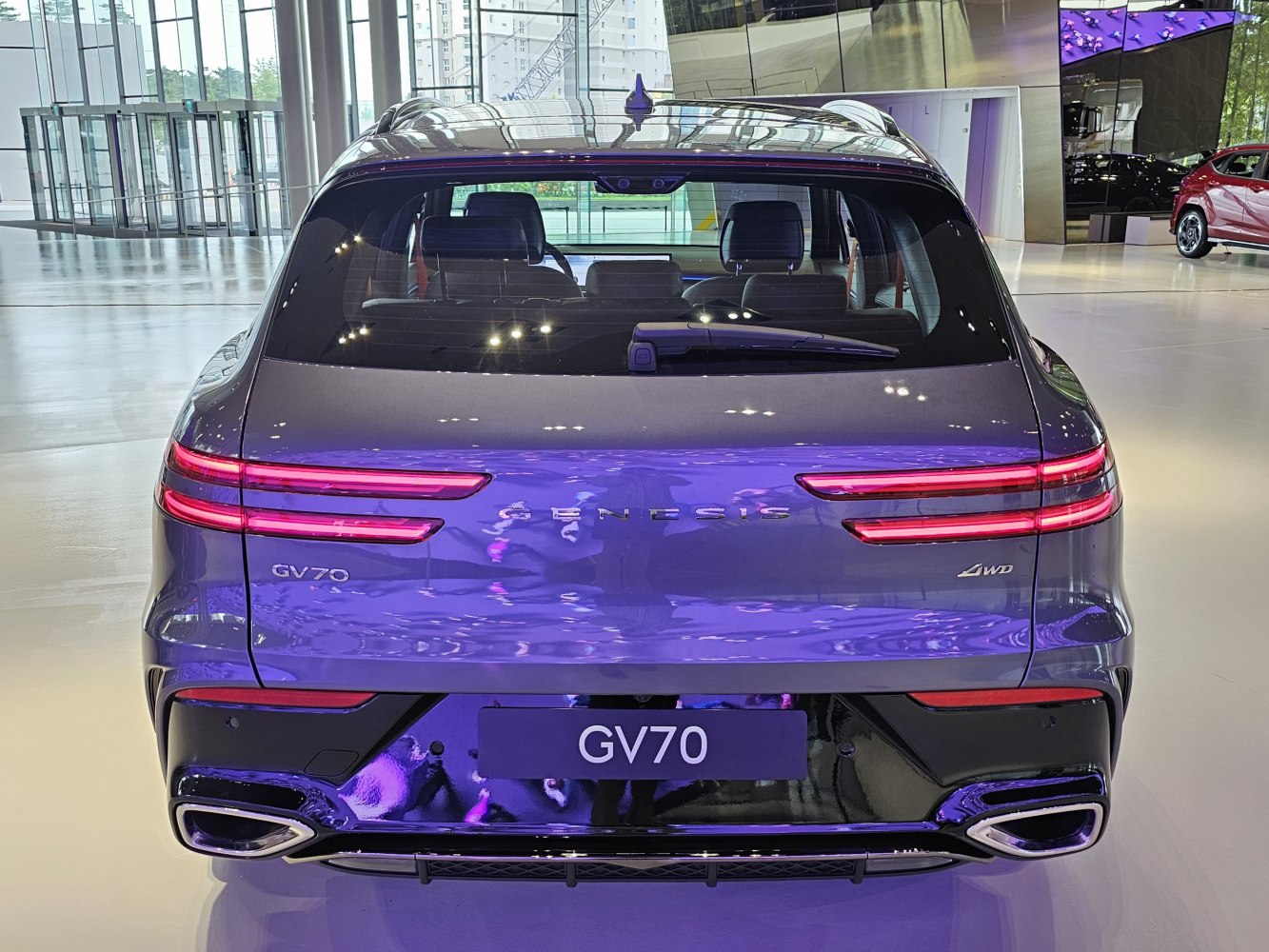 Rear view with LED taillights, dual exhaust tips, and AWD badge
