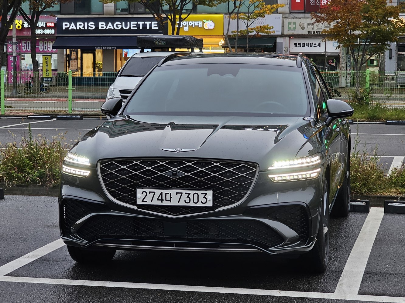 Front view of modern SUV with LED headlights and mesh grille