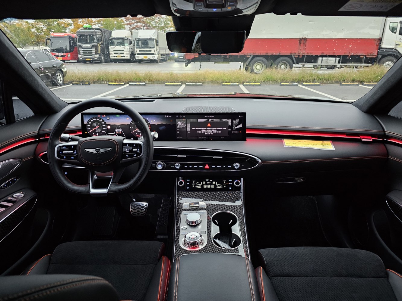 Dual digital displays with ambient red lighting in luxury SUV interior