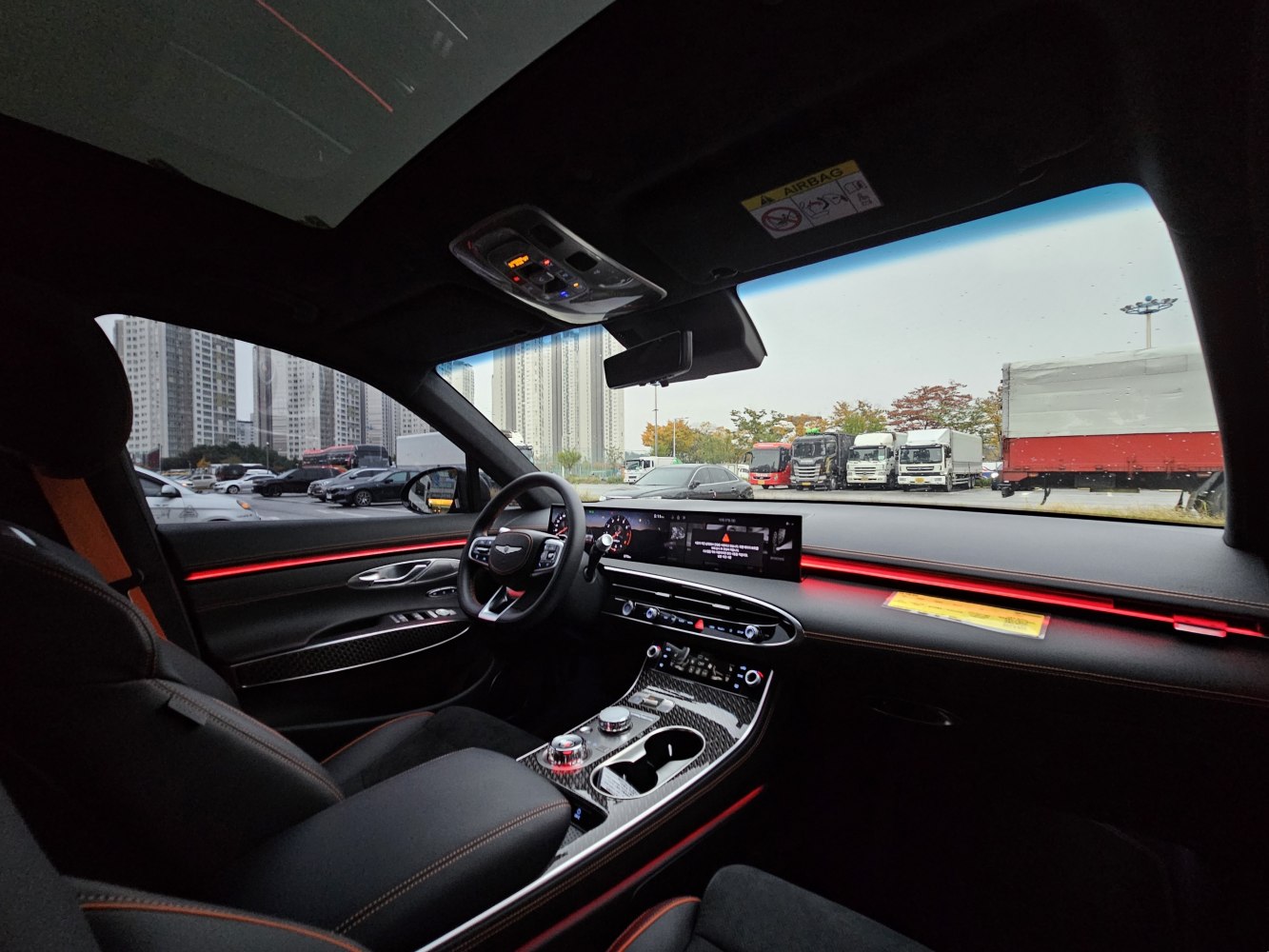 Modern luxury interior with digital dashboard and red ambient lighting