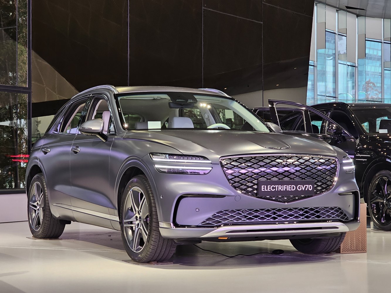 Luxury electric SUV with divided headlights and distinctive mesh grille