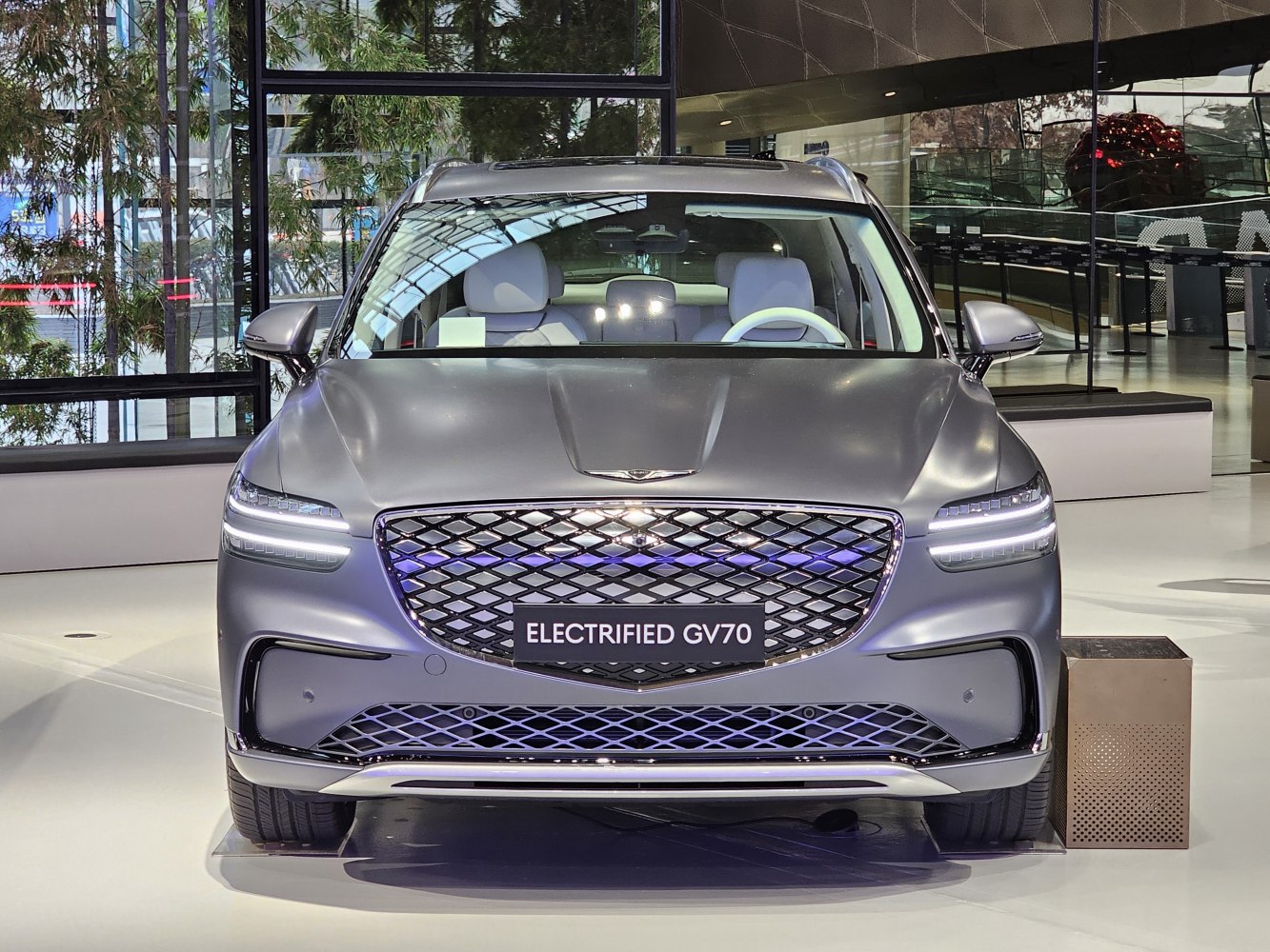 Electrified SUV front view with LED headlights and patterned grille
