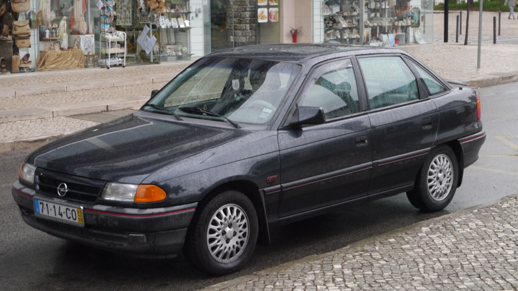 Classic early 90s compact hatchback with alloy wheels and rounded front