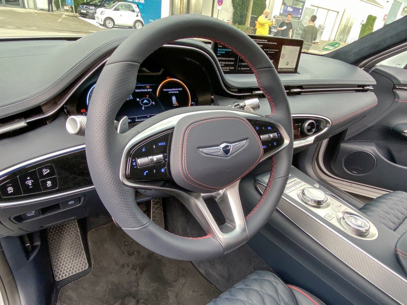 Leather steering wheel with red stitching and digital dashboard display