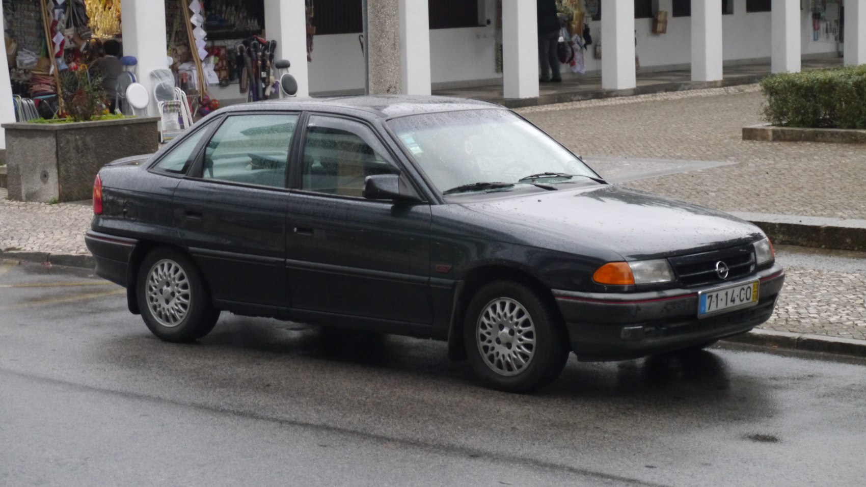 Mid-1990s sedan with alloy wheels and classic side mirrors