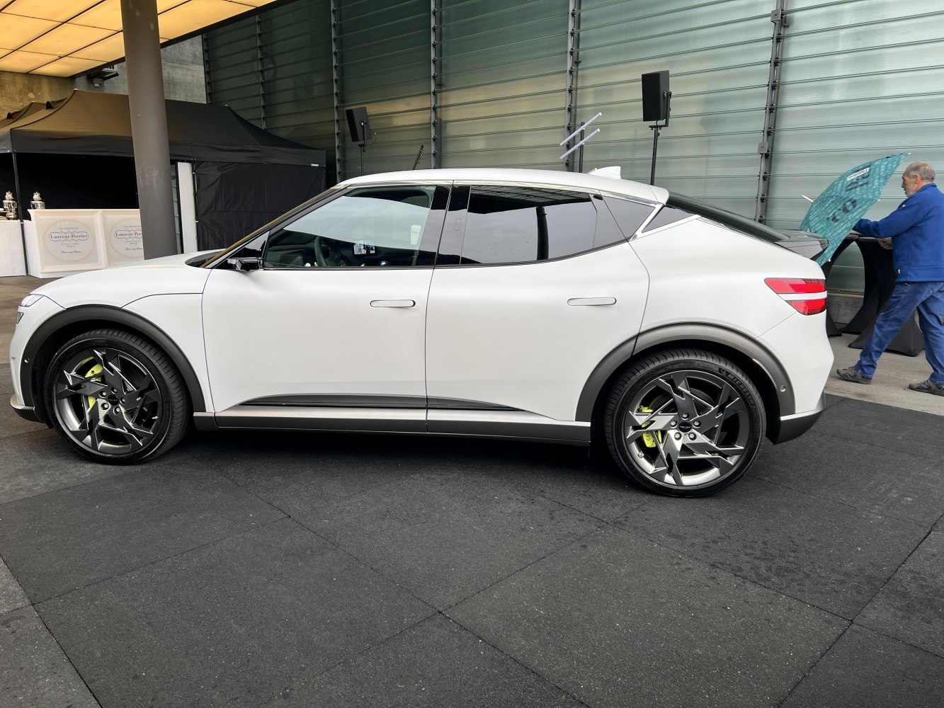 White electric SUV side profile with distinctive alloy wheels and tinted windows.